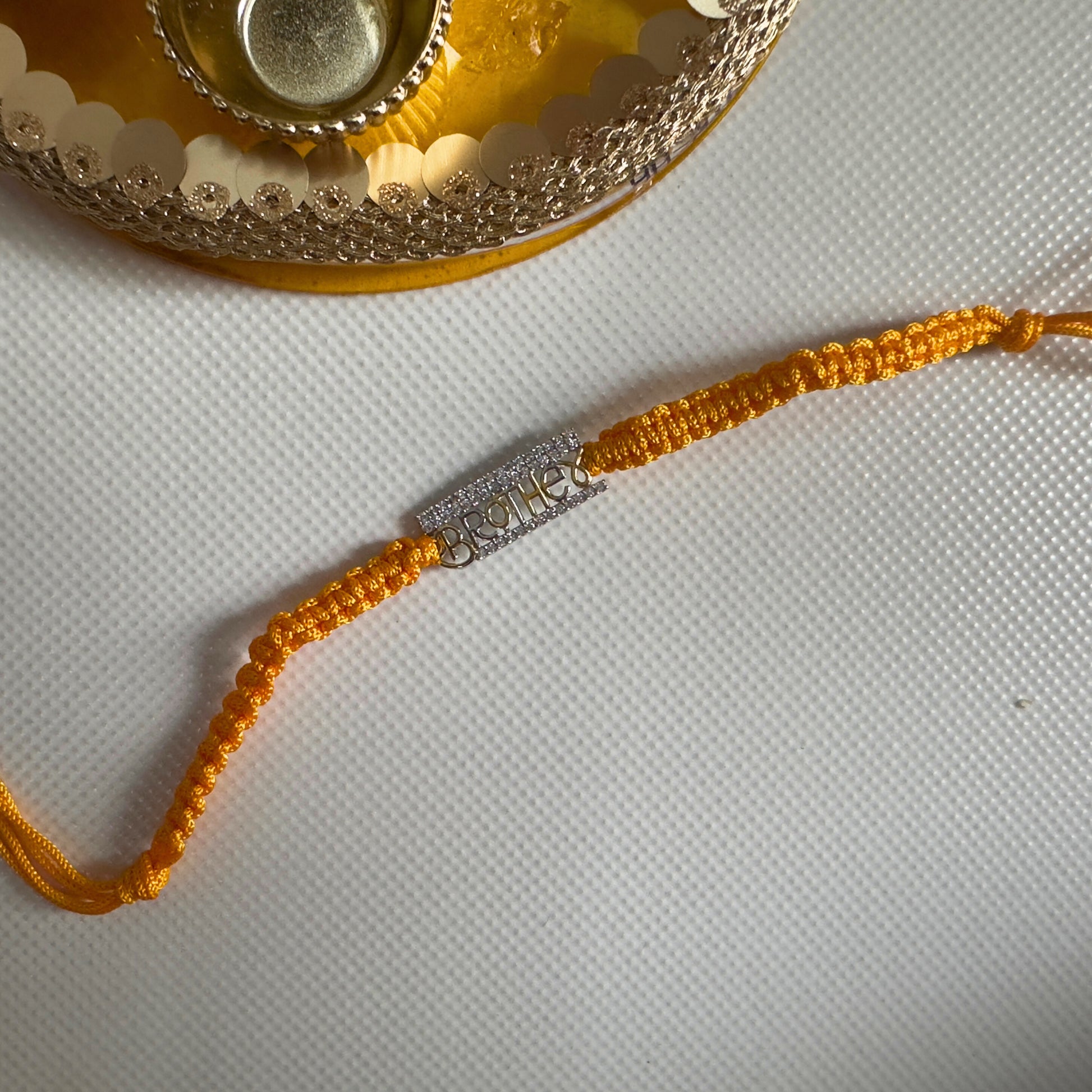 Brother Rakhi in 92.5 Sterling Silver With Braided Yellow Thread