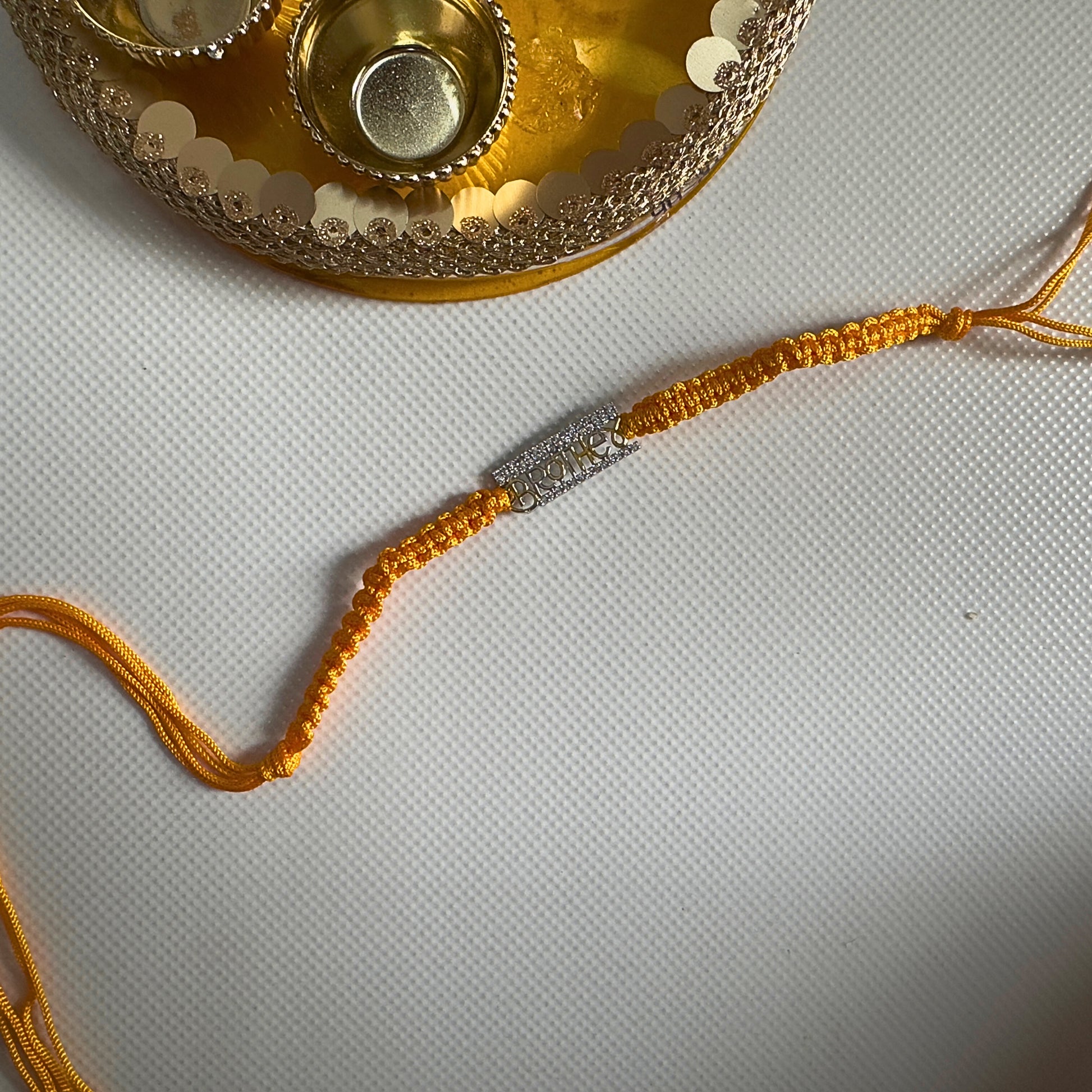 Brother Rakhi in 92.5 Sterling Silver With Braided Yellow Thread